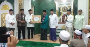 Wakil Gubernur Jambi Drs. H. Abdullah Sani, M.Pd.I. menyerahkan sertifikat penghargaan kepada masjid perkantoran Guru Makki di bank 9 Jambi