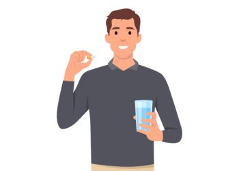 Young man cartoon standing and holding glass of water and pill capsule painkiller or vitamin medication in hands concept character . Flat vector illustration isolated on white background